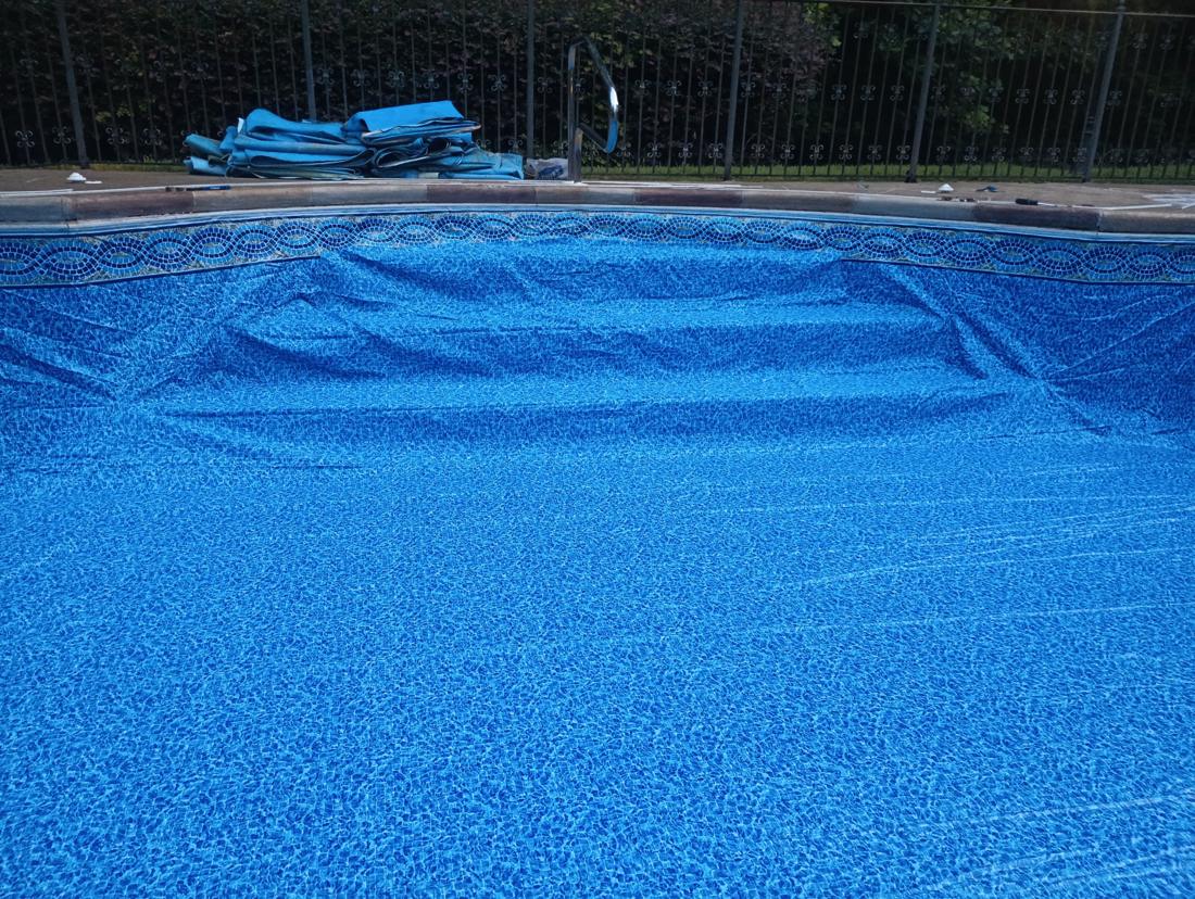 New liner set over the steps, old liner folded on the deck