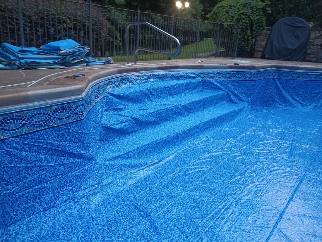 New liner with the mosaic border set over the corner steps