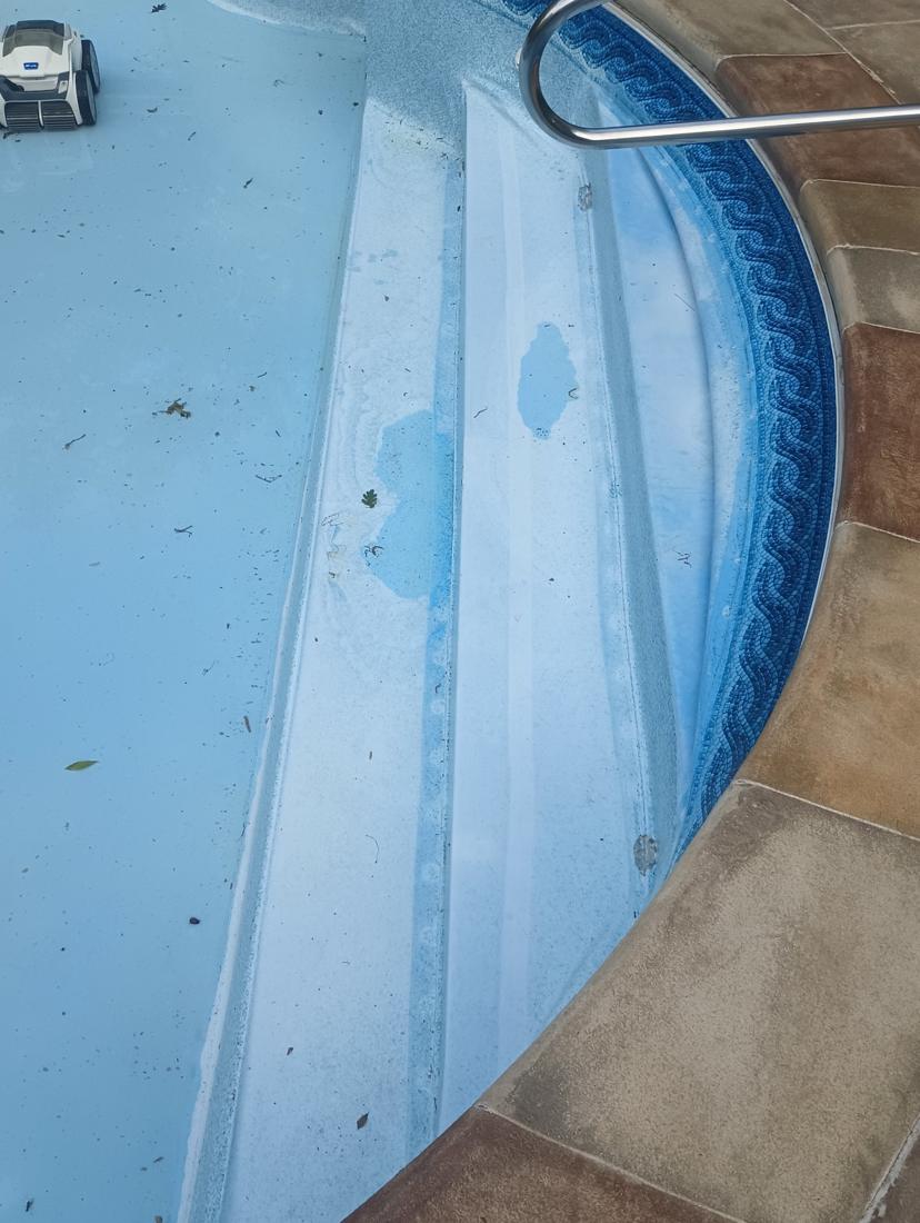 Close-up of the faded, worn liner on the steps