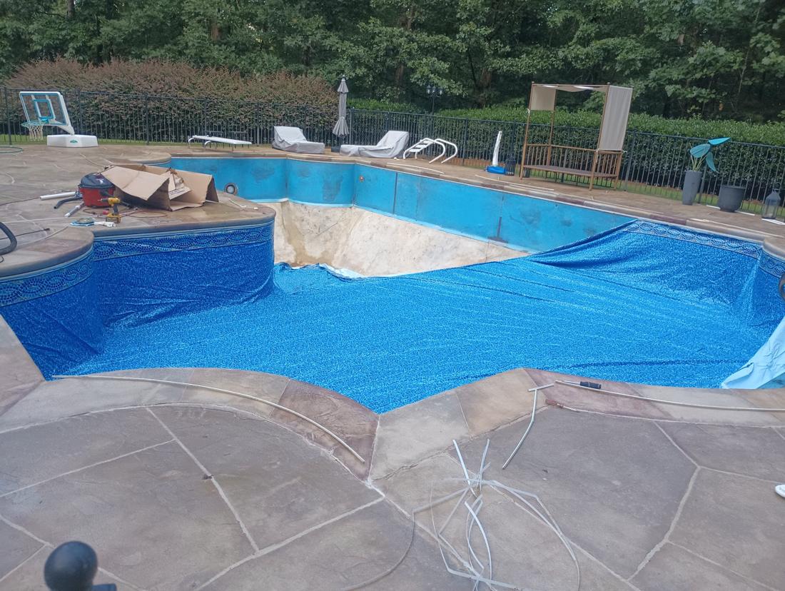 New liner spread across the floor, walls still bare
