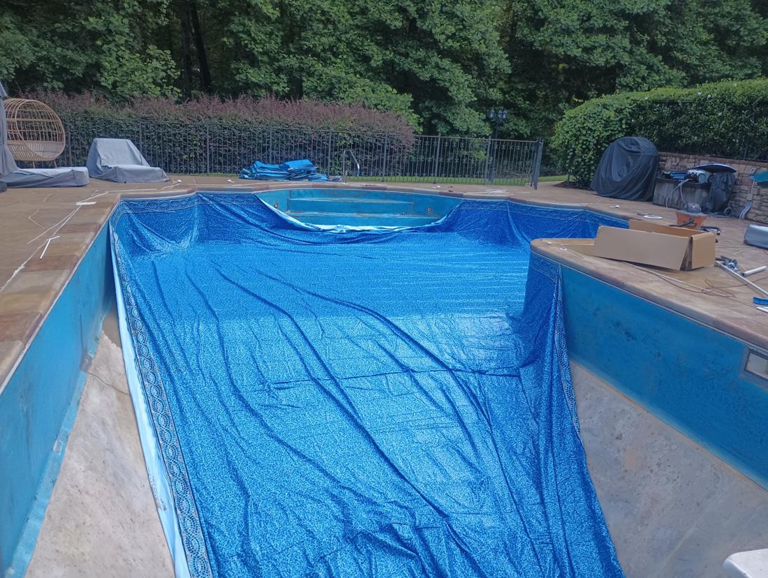 New liner laid out from the deep end toward the steps