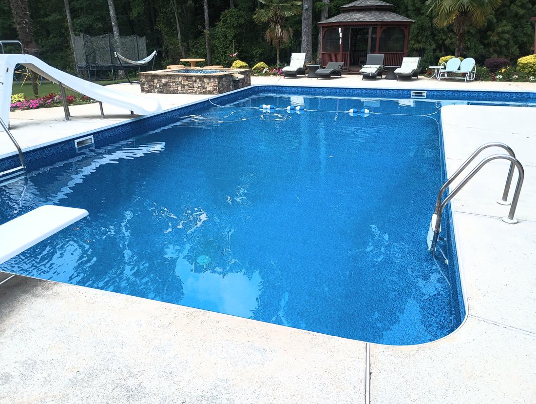 Pool filled with clear water, gazebo behind