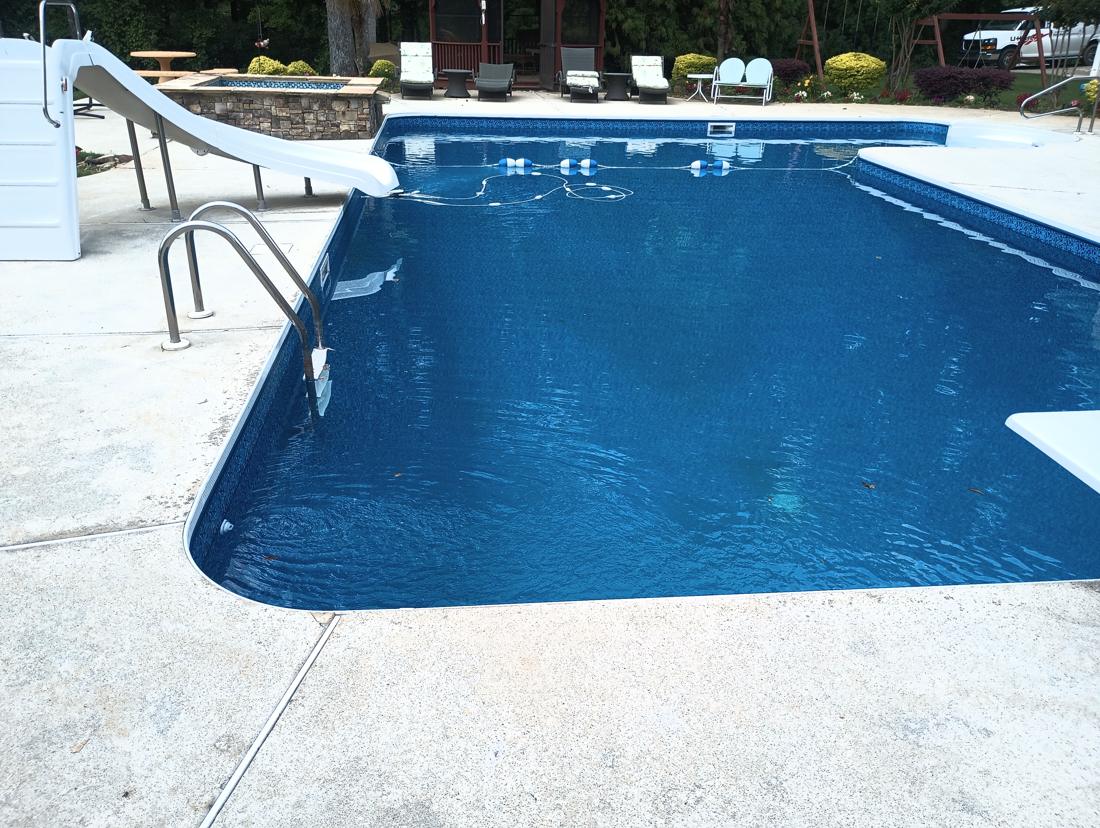 Filled pool with the slide and rope float line