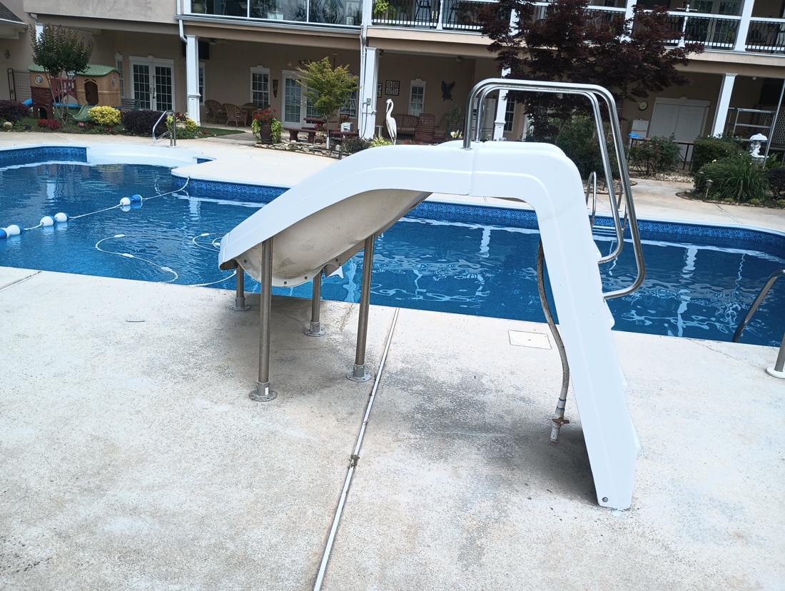 Restored slide beside the finished pool