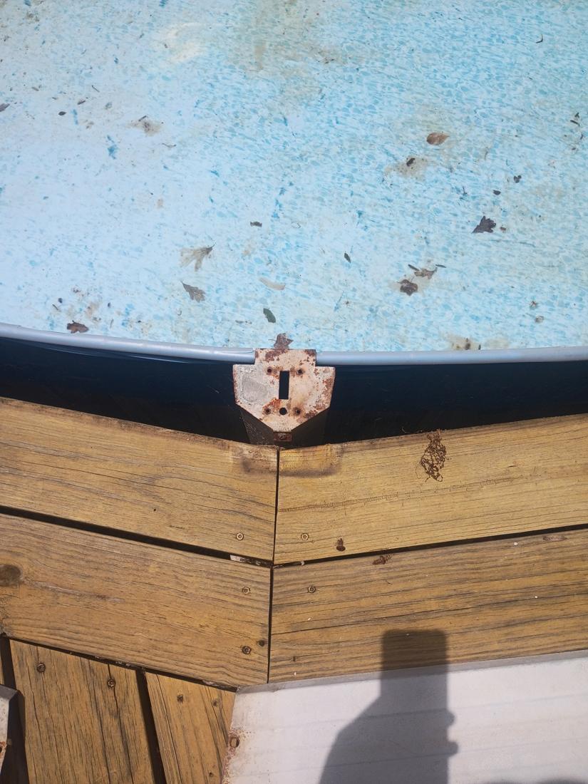 Faded old liner with leaves and a rusted top plate at the wall