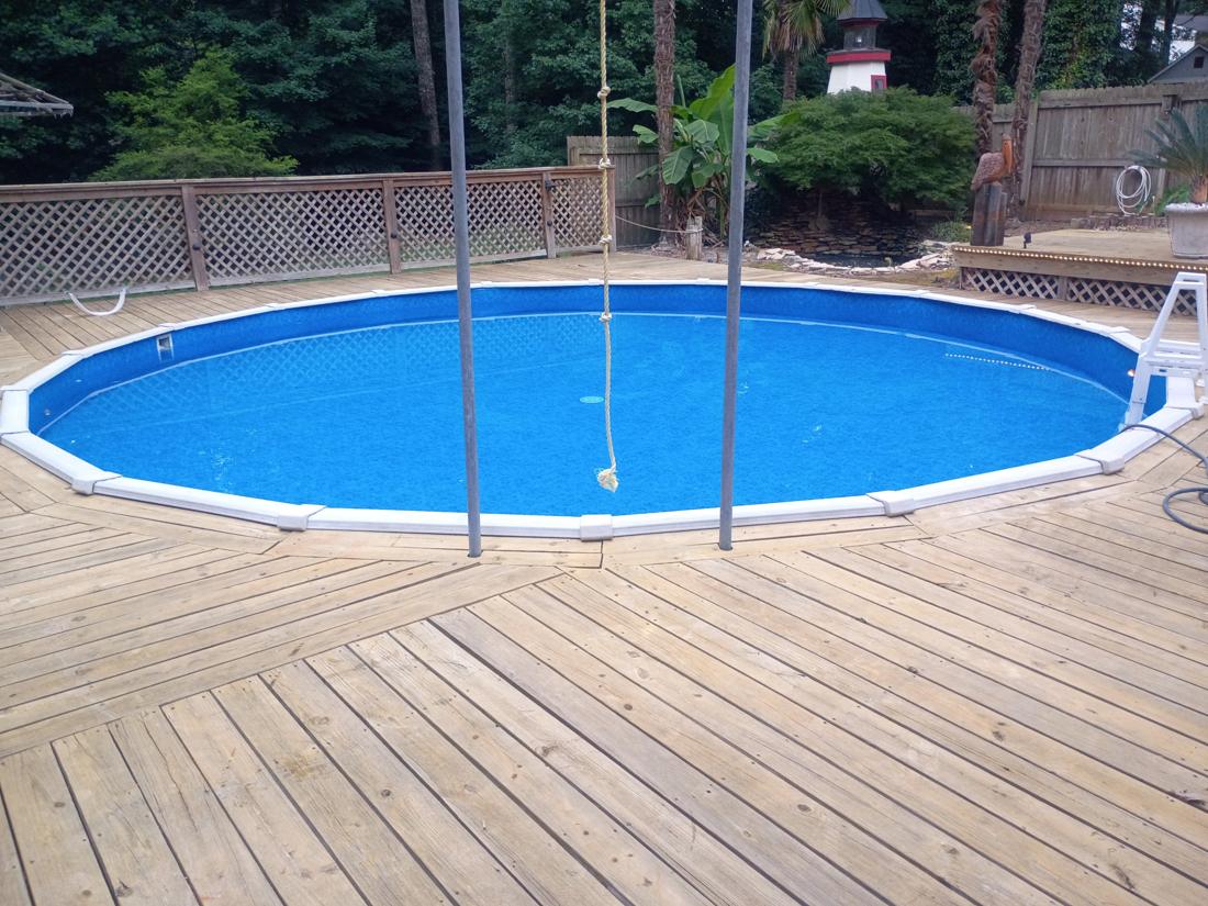 Finished round pool with new liner, top rails back on, set in the deck