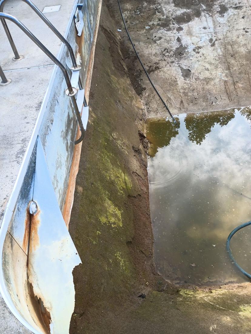 Old liner torn away from rusted steel walls