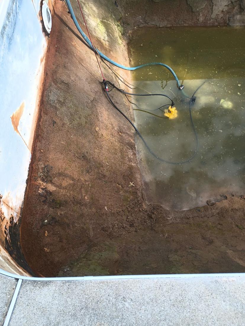 Pump draining the remaining water from the deep end
